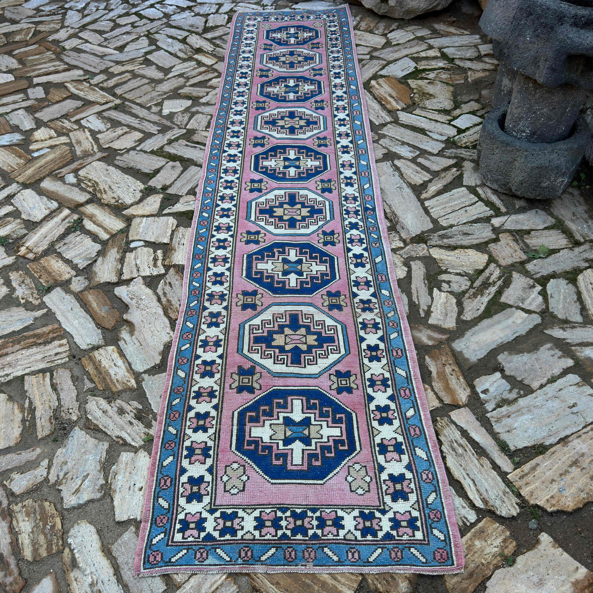 Pink 3' x 12' turkish runner rug in wool and cotton, shown on the floor.