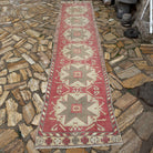 Pale Red 3' x 13' turkish runner rug in wool and cotton, shown on the floor.