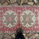 1970s pale red turkish runner rug with medallion design, hand-knotted weave and low pile.