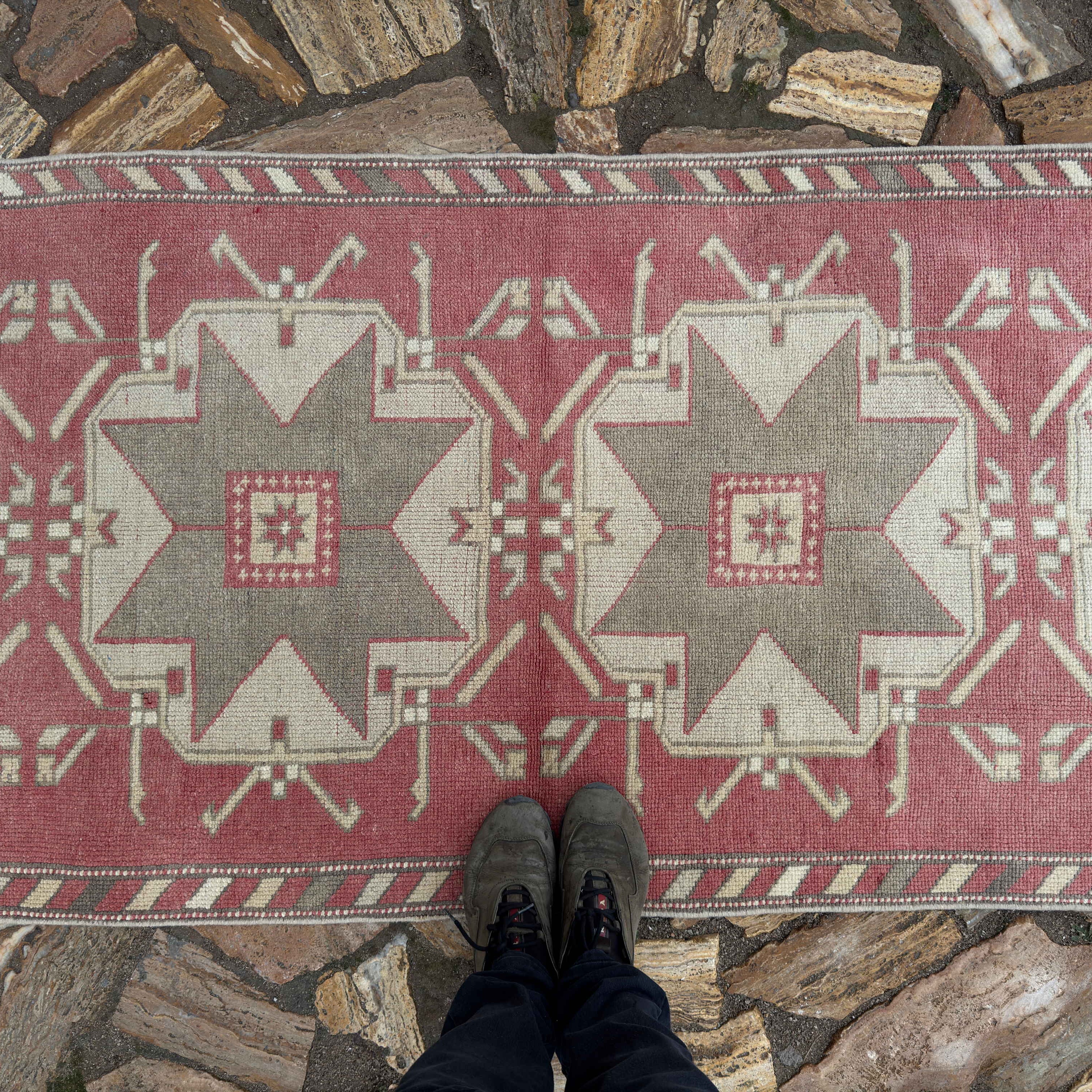 1970s pale red turkish runner rug with medallion design, hand-knotted weave and low pile.