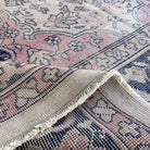 Close-up of the blue turkish traditional rug showing medallion details, hand-knotted weave, wool and cotton and low pile.