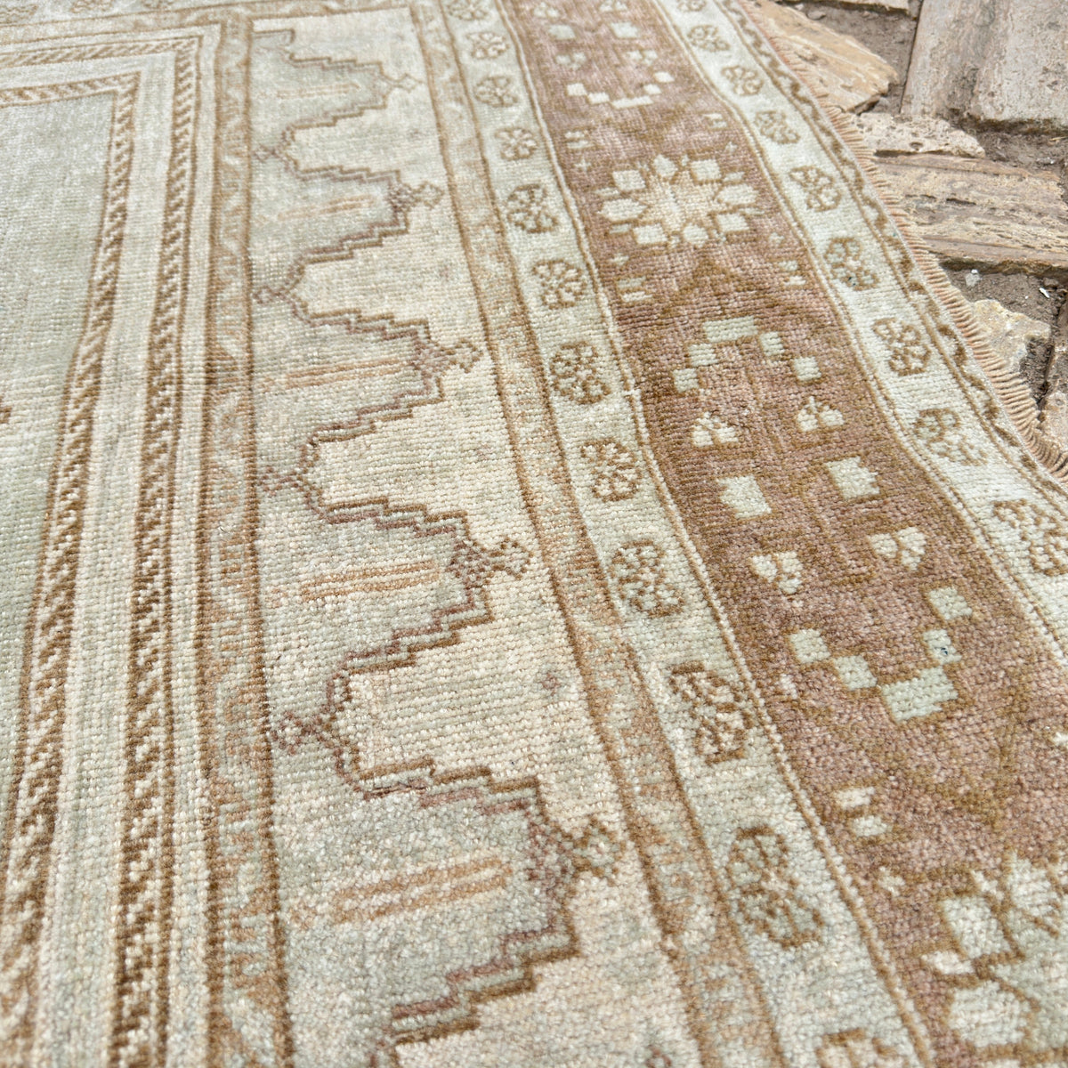 Close-up of the brown turkish wool rug showing medallion details, hand-knotted weave, wool and cotton and low pile.
