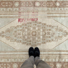 1970s brown turkish wool rug with medallion design, hand-knotted weave and low pile.