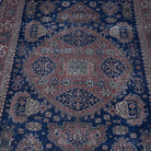 Close-up of the blue Turkish unique vintage oushak rug showing traditional details, hand-knotted weave, wool and cotton and low pile.
