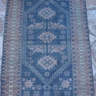 Close-up of the blue Turkish unique vintage rug showing traditional details, hand-knotted weave, wool and low pile.