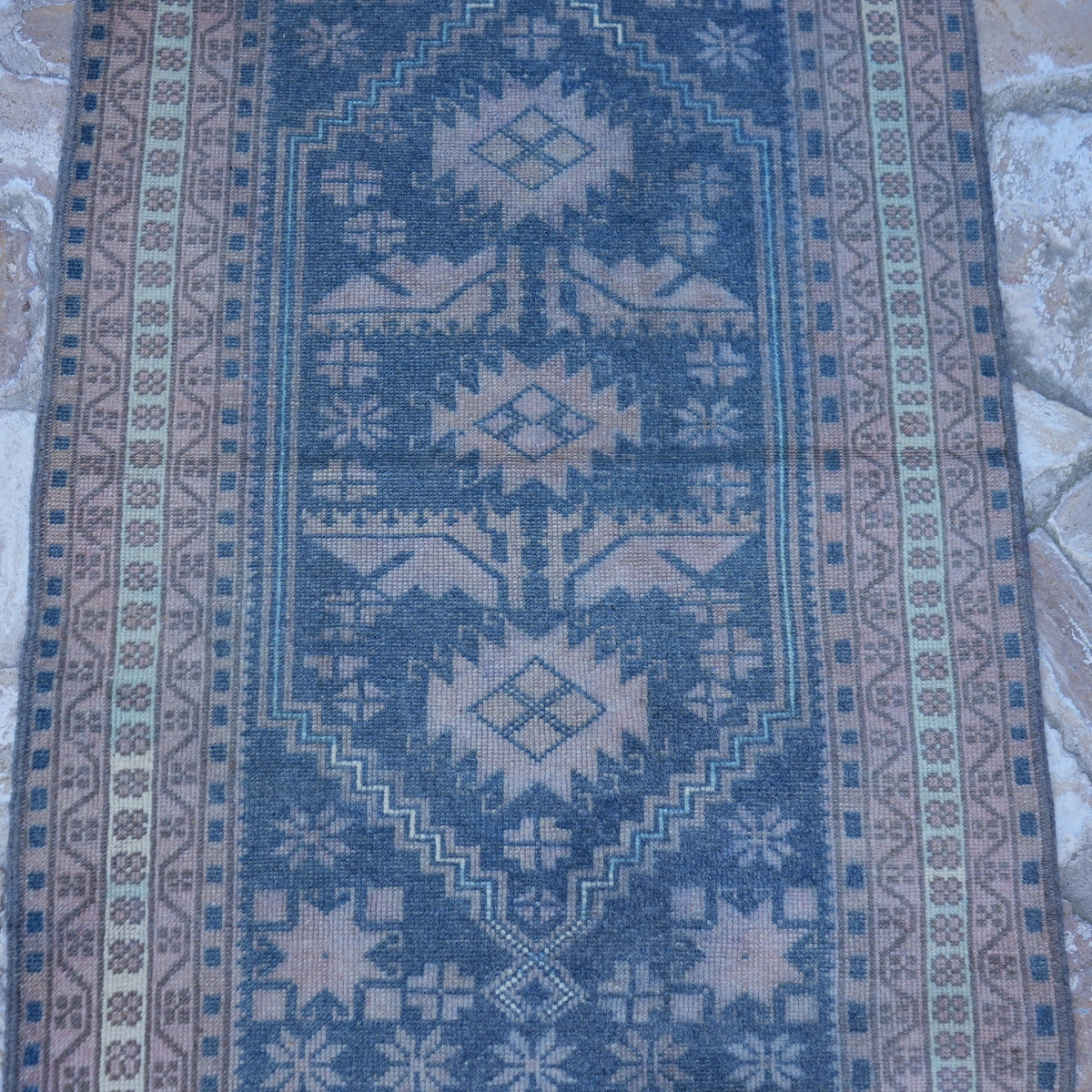 Close-up of the blue Turkish unique vintage rug showing traditional details, hand-knotted weave, wool and low pile.