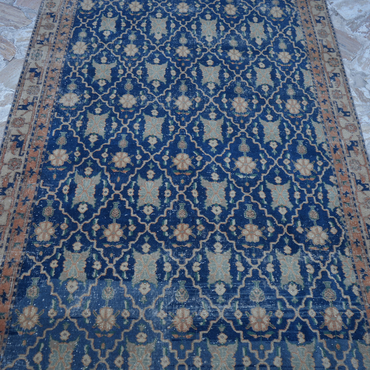 Close-up of the blue Turkish unique vintage rug showing geometric details, hand-knotted weave, wool and cotton and low pile.