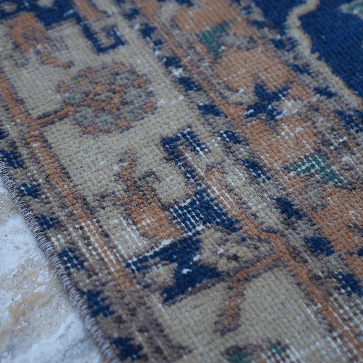 Blue 5' x 9' Turkish unique vintage rug in wool and cotton, shown on the floor.