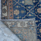 1970s blue Turkish unique vintage rug with geometric design, hand-knotted weave and low pile.