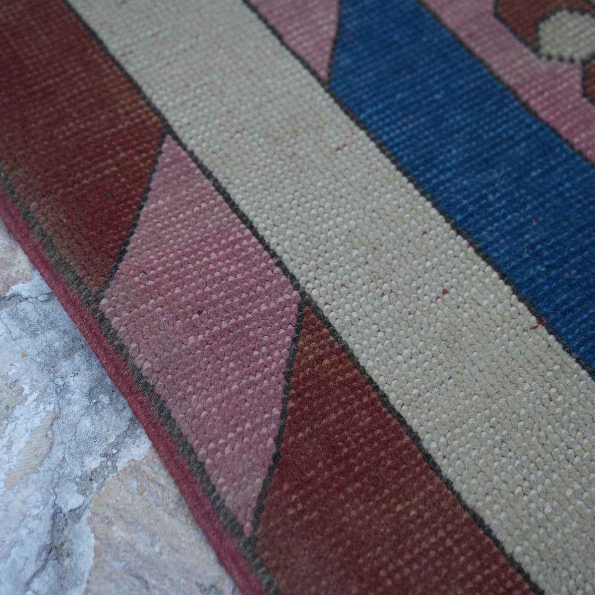 Pink 7' x 9' Turkish unique vintage rug in wool, shown on the floor.
