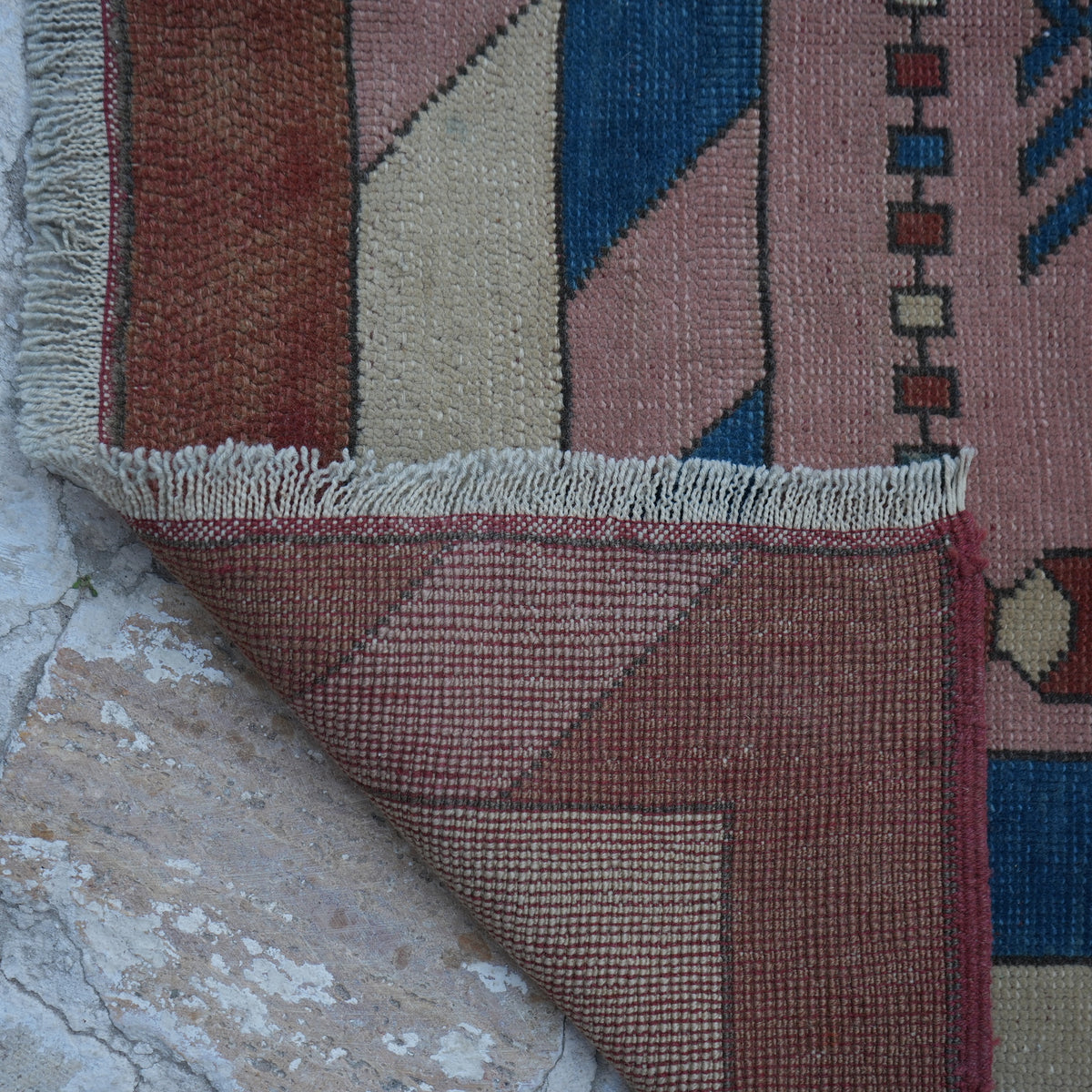 1970s pink Turkish unique vintage rug with geometric design, hand-knotted weave and low pile.