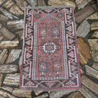 Pale Red 2' x 4' vintage Turkish anatolia rug in wool and cotton, shown on the floor.