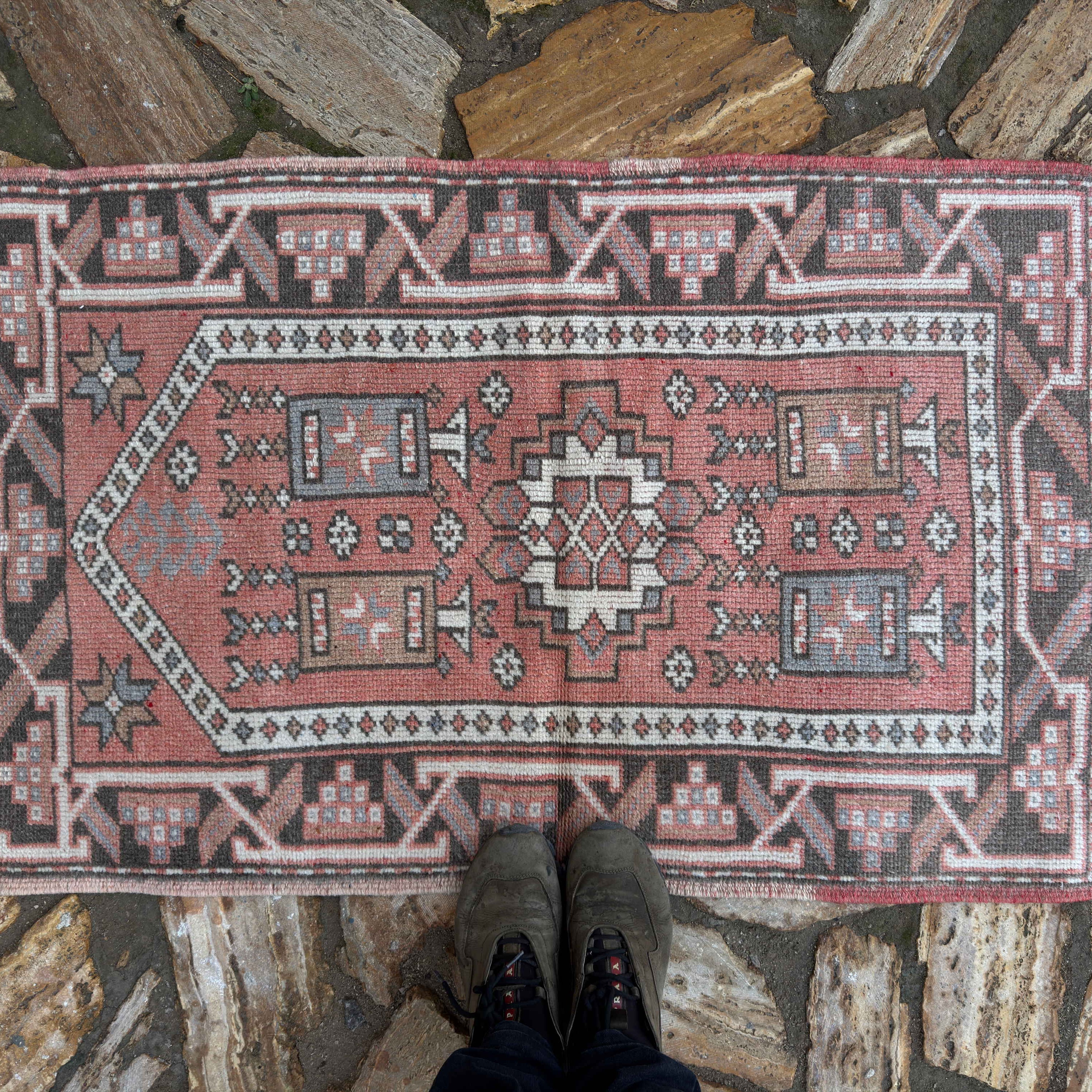 1970s pale red vintage Turkish anatolia rug with traditional design, hand-knotted weave and low pile.