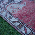 Red 2' x 3' vintage Turkish anatolian rug in wool and cotton, shown on the floor.