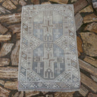 Pale Blue 2' x 4' vintage Turkish anatolian rug in wool and cotton, shown on the floor.