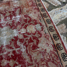 Close-up of the red vintage Turkish anatolian rug showing medallion details, hand-knotted weave, wool and cotton and low pile.