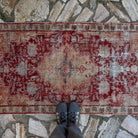 1970s red vintage Turkish anatolian rug with medallion design, hand-knotted weave and low pile.