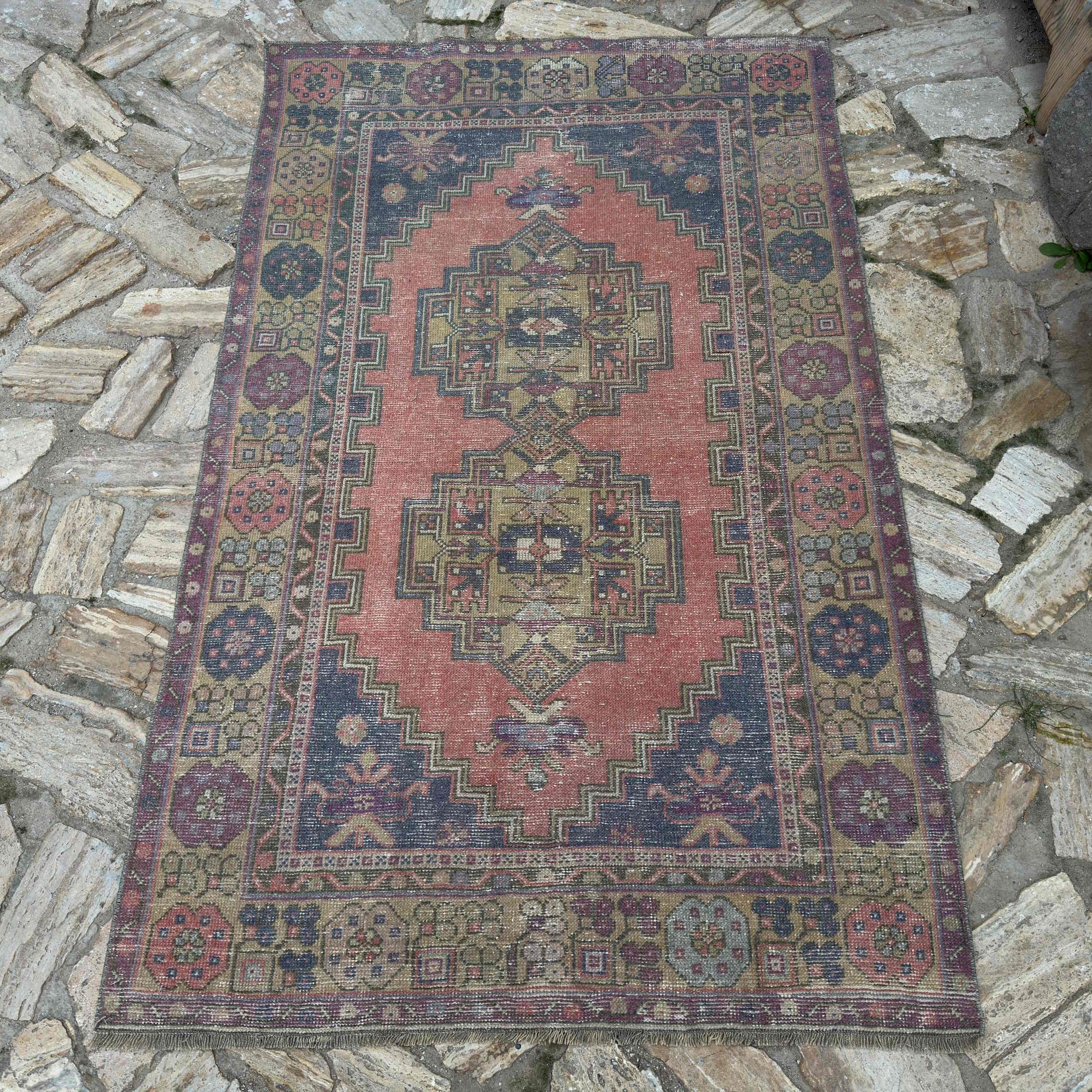 Red 4' x 6' vintage Turkish anatolian rug in wool and cotton, shown on the floor.