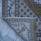 1970s olive green vintage Turkish anatolian rug with traditional design, hand-knotted weave and low pile.