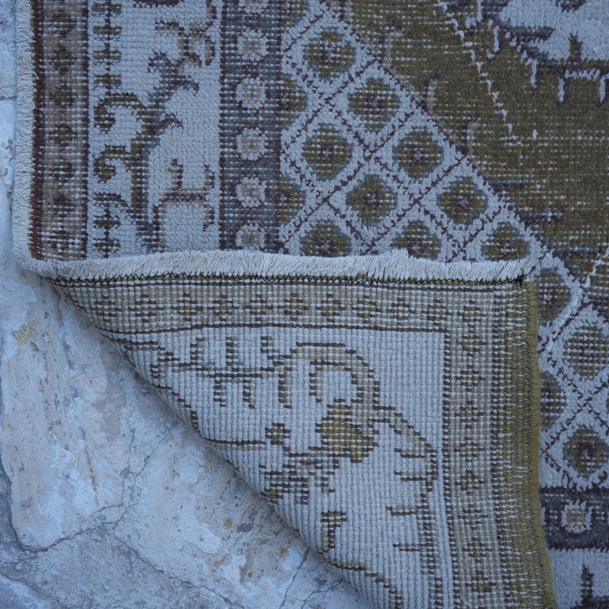 1970s olive green vintage Turkish anatolian rug with traditional design, hand-knotted weave and low pile.