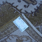 Olive Green 4' x 7' vintage Turkish anatolian rug from the 1970s with traditional design.