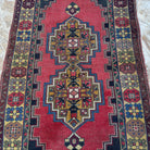 1970s red vintage Turkish anatolian rug with traditional design, hand-knotted weave and low pile.