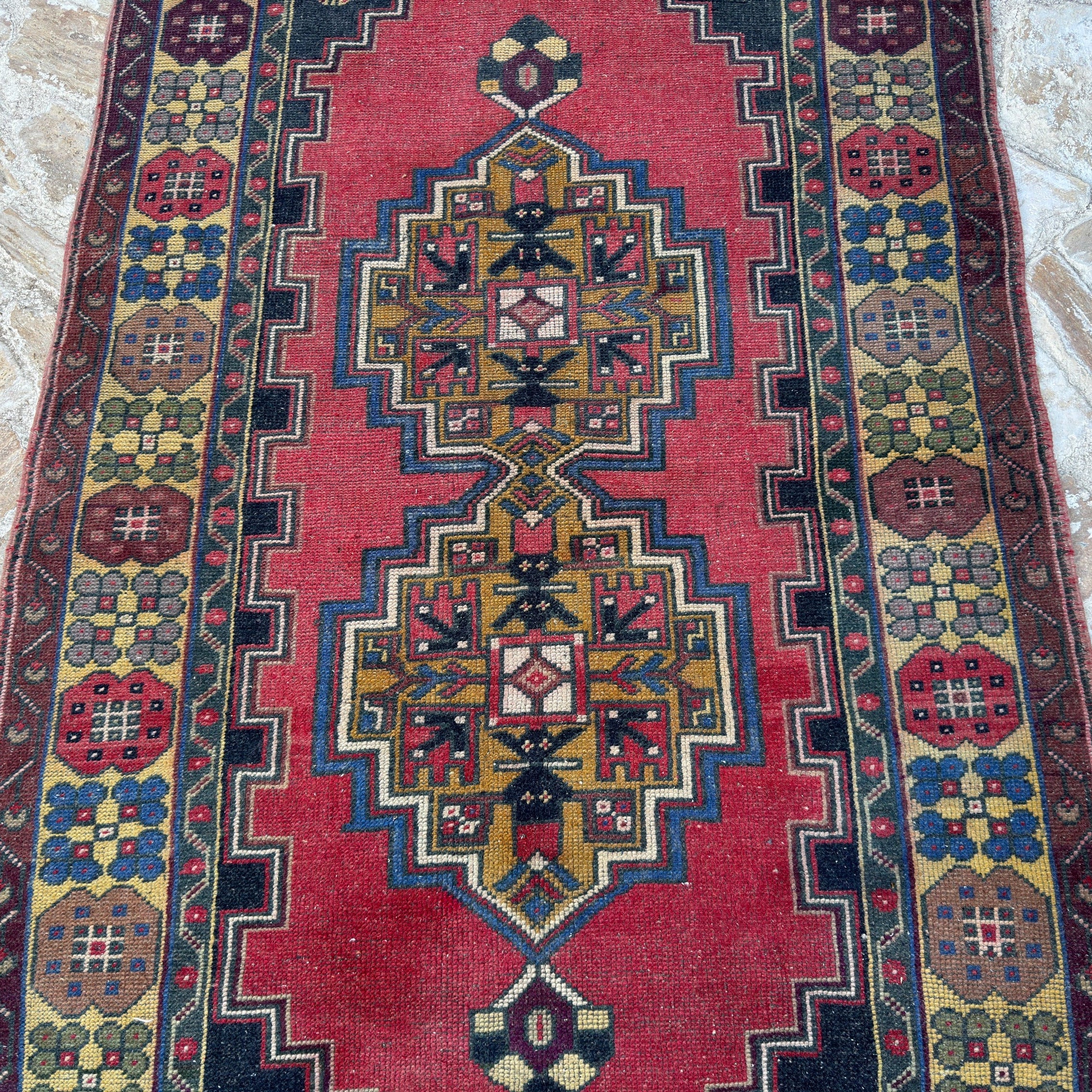 1970s red vintage Turkish anatolian rug with traditional design, hand-knotted weave and low pile.