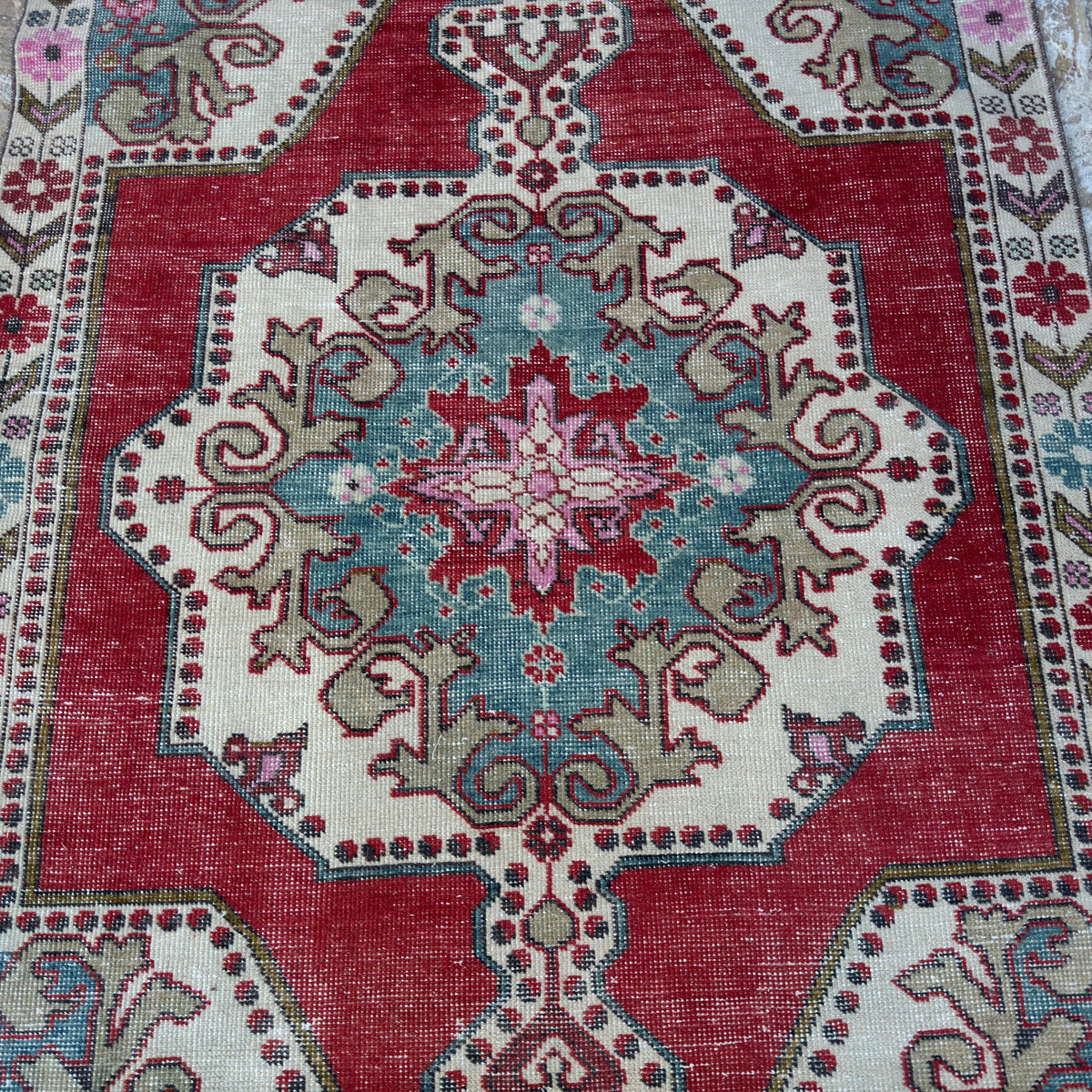 1970s red vintage Turkish anatolian rug with traditional design, hand-knotted weave and low pile.