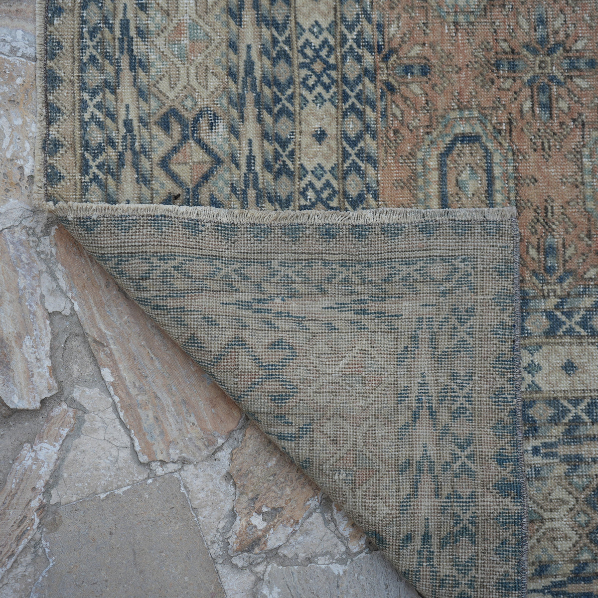 1970s pale orange vintage Turkish anatolian rug with geometric design, hand-knotted weave and low pile.