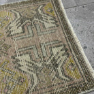 Close-up of the red vintage Turkish area carpet showing traditional details, hand-knotted weave, wool and cotton and low pile.
