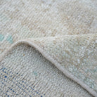 1970s beige vintage Turkish area rug with neutral design, hand-knotted weave and low pile.