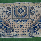 Close-up of the blue vintage Turkish area rug showing traditional details, hand-knotted weave, wool and cotton and low pile.