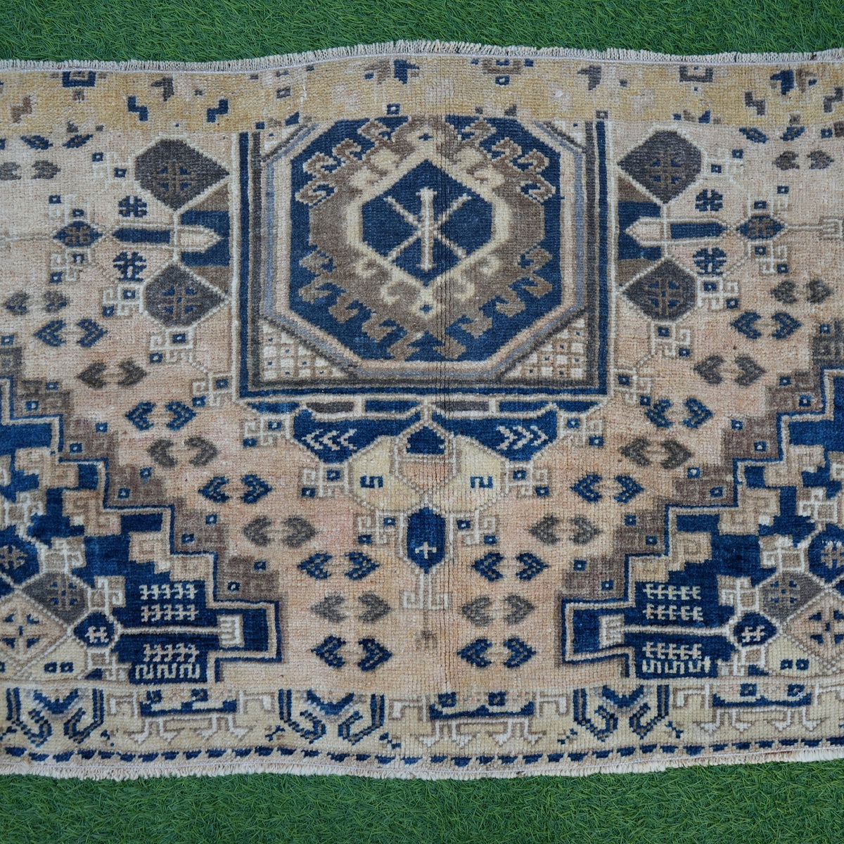 Close-up of the blue vintage Turkish area rug showing traditional details, hand-knotted weave, wool and cotton and low pile.