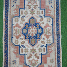 Close-up of the blue vintage Turkish area rug showing traditional details, hand-knotted weave, wool and cotton and low pile.