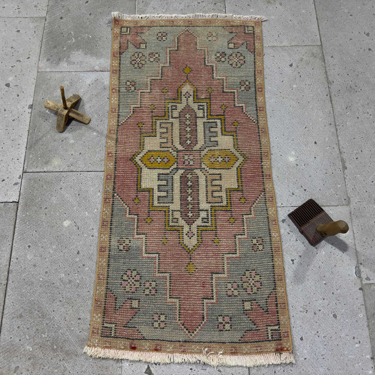 Red 2' x 3' vintage Turkish area rug in wool and cotton, shown on the floor.