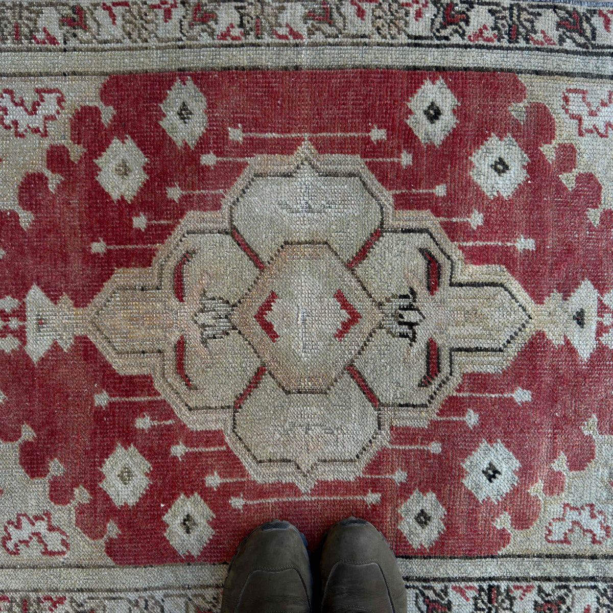 1970s red vintage Turkish area rug with traditional design, hand-knotted weave and low pile.