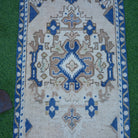 Close-up of the blue vintage Turkish area rug showing traditional details, hand-knotted weave, wool and cotton and low pile.