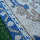 Blue 2' x 4' vintage Turkish area rug in wool and cotton, shown on the floor.