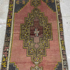 1970s pink vintage Turkish area rug with traditional design, hand-knotted weave and low pile.