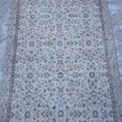Close-up of the beige vintage Turkish area rug showing traditional details, hand-knotted weave, wool and cotton and low pile.