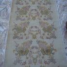 Close-up of the beige vintage Turkish area rug showing traditional details, hand-knotted weave, wool and cotton and low pile.