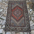 Red 3' x 6' vintage Turkish area rug in wool and cotton, shown on the floor.