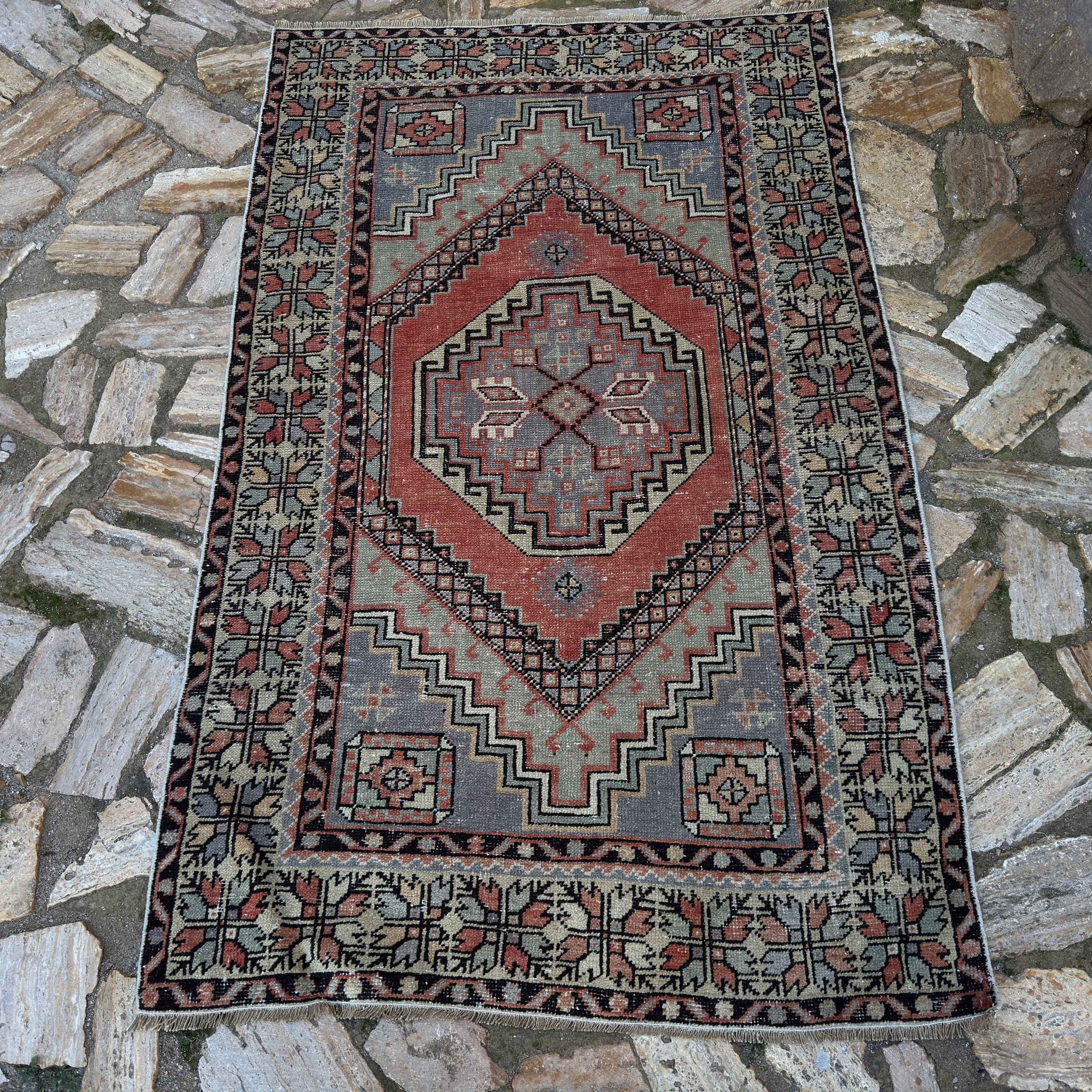 Red 3' x 6' vintage Turkish area rug in wool and cotton, shown on the floor.