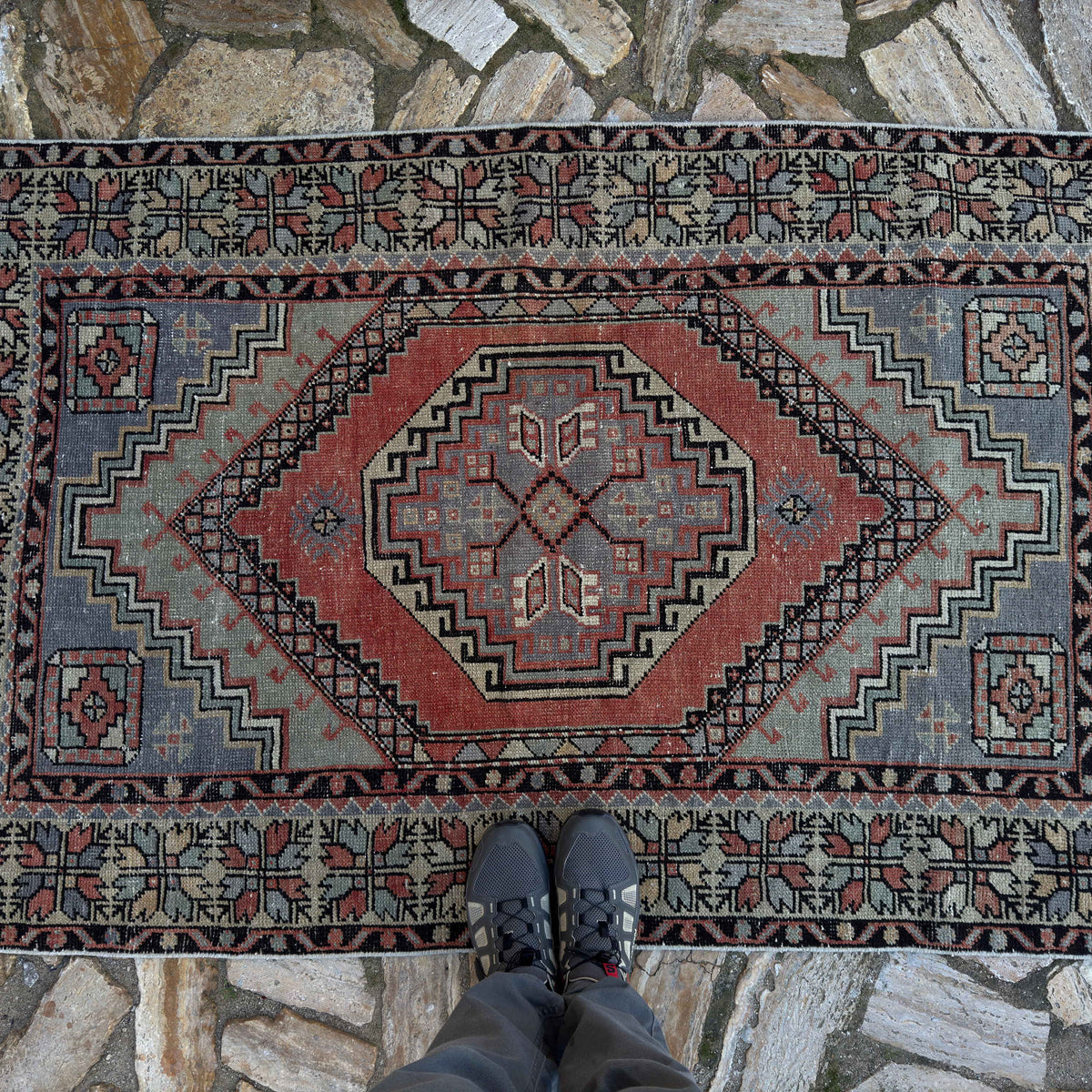 1970s red vintage Turkish area rug with traditional design, hand-knotted weave and low pile.