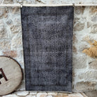 Black 4' x 6' vintage area rug with overdyed design, handmade in Turkey – Charley.