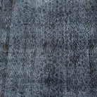 1970s black vintage Turkish area rug with overdyed design, hand-knotted weave and low pile.