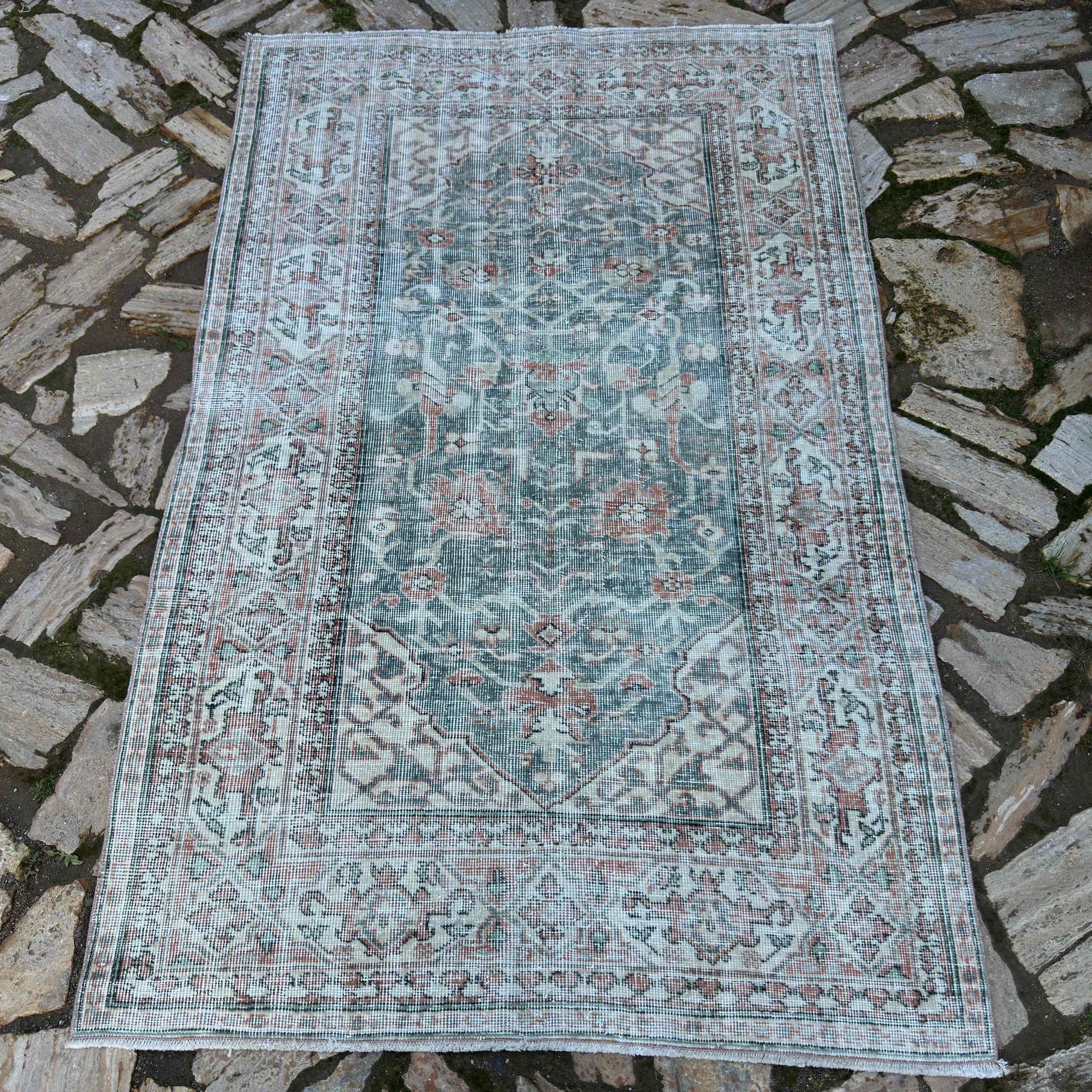 Green 4' x 6' vintage Turkish area rug in wool and cotton, shown on the floor.