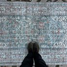 1970s green vintage Turkish area rug with floral design, hand-knotted weave and low pile.