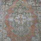 Pale Orange 4' x 6' vintage Turkish area rug in wool and cotton, shown on the floor.