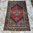 Red 4' x 6' vintage Turkish area rug in wool and cotton, shown on the floor.